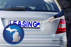 michigan silver car with LEASING painted in blue