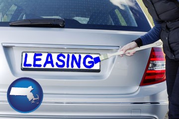 silver car with LEASING painted in blue - with Massachusetts icon