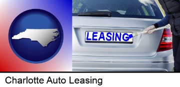 silver car with LEASING painted in blue in Charlotte, NC